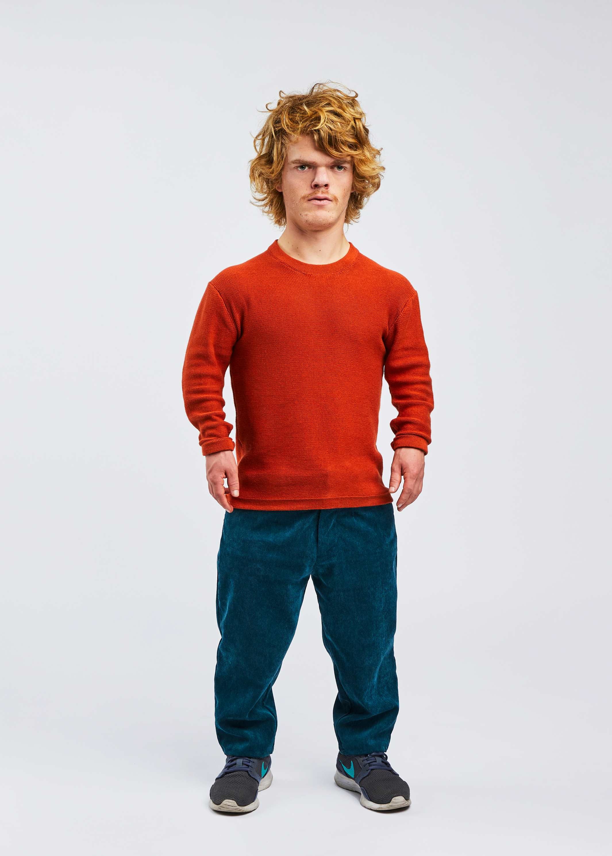 man with dwarfism wearing red pullover and blue corduroy pants