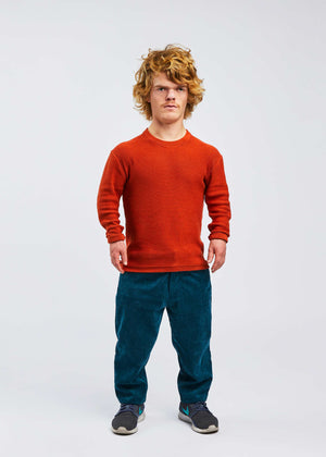 man with dwarfism wearing red pullover and blue corduroy pants