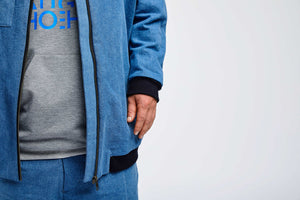 detailed view of sleeve of blue college jacket for people with dwarfism