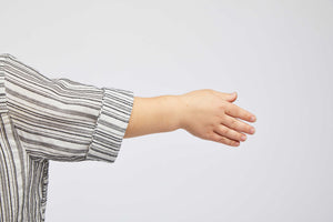 detailed view of arm with black and white striped short sleeved blouse