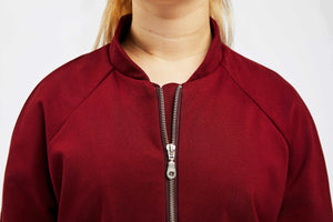 detailed view of zipped up collar of red college jacket