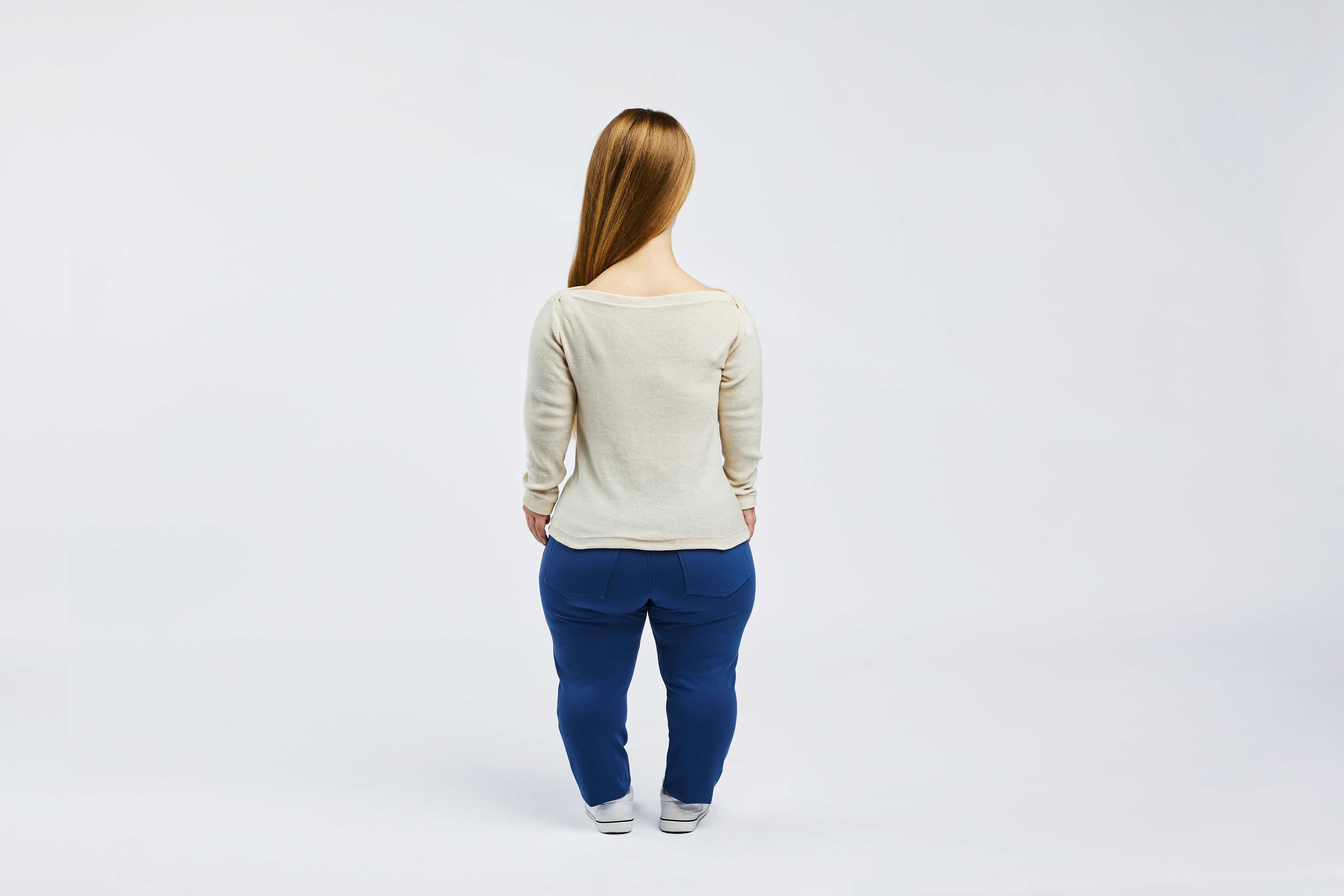 woman with dwarfism wearing white pullover 