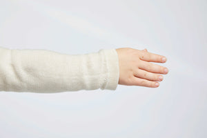 detailed view of sleeve of white pullover for people with dwarfism