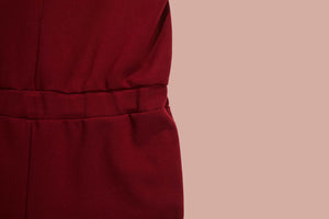 detailed view on red jumpsuit showing fit at the waist