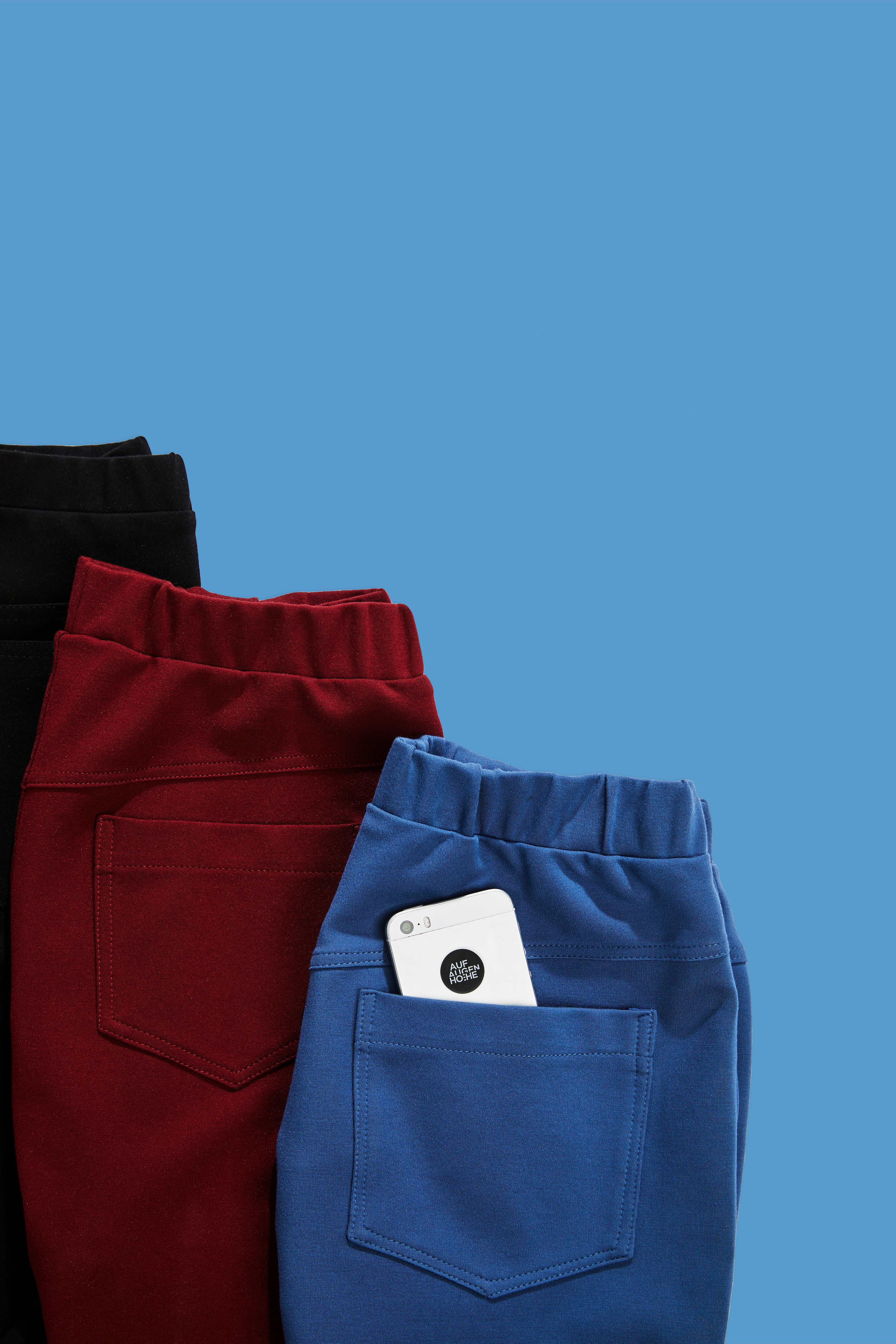 detailed view of backpockets of blue red and black pants