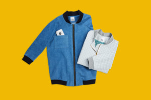 blue college jacket and folded up light blue grid texture college jacket on yellow background