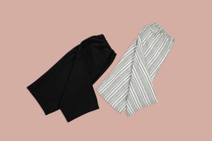 black and black and white striped pants on rose background
