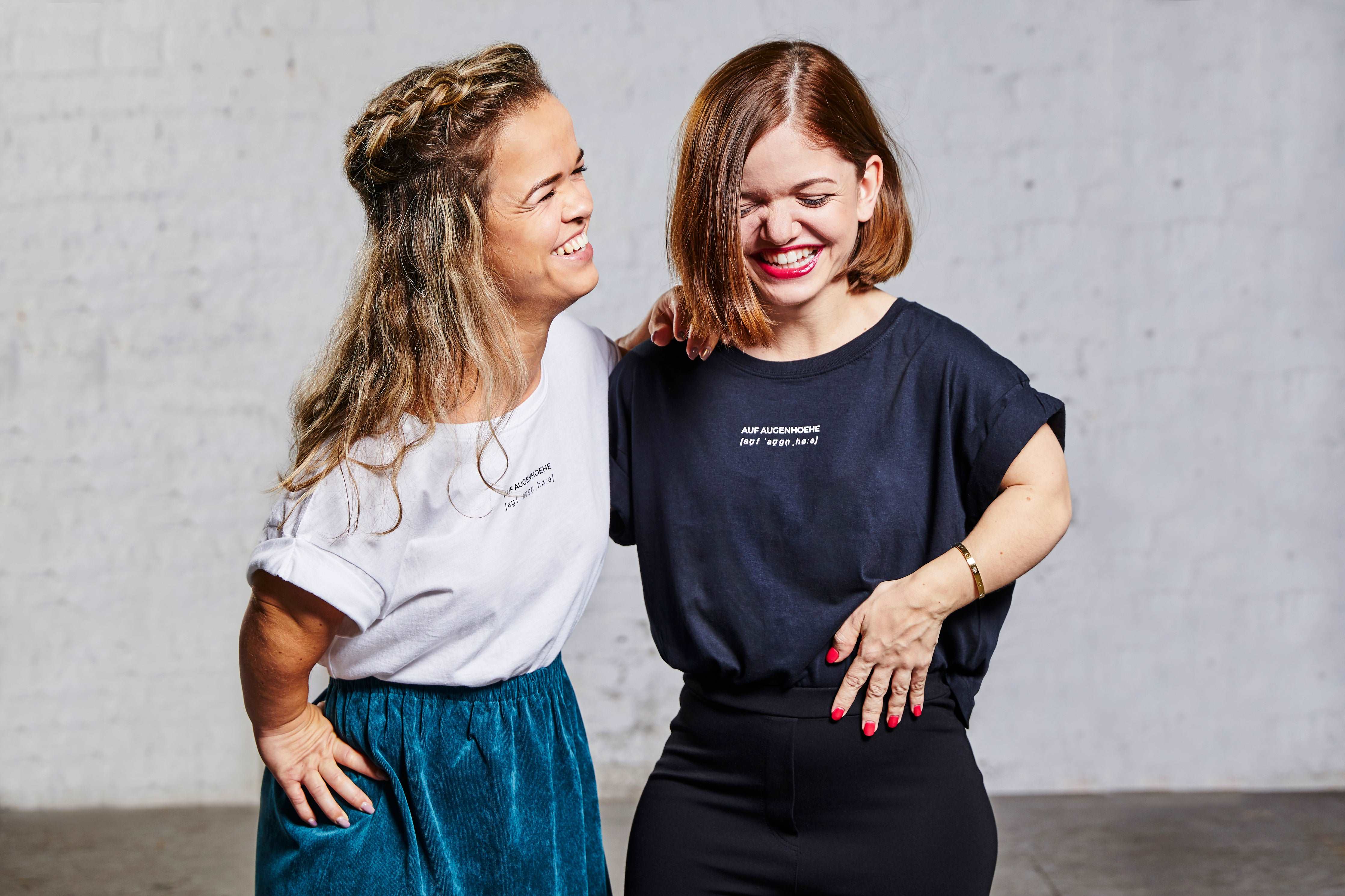 two women with dwarfism laughing together