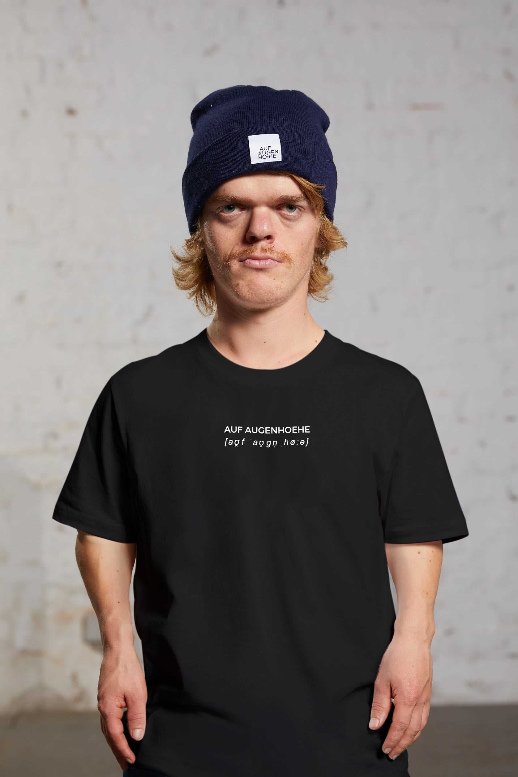 man with dwarfism wearing black t-shirt with small brand logo