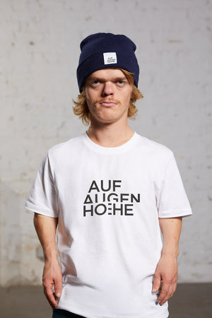 man with dwarfism wearing a white t-shirt with black brand logo