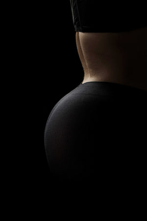 dark and moody image of black pair of tights for people with dwarfism