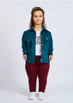 woman with dwarfism wearing blue corduroy jacket with wine red pants and white shirt