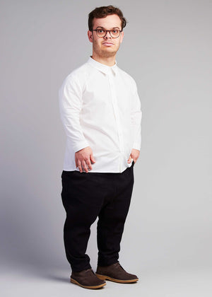 man with dwarfism wearing white shirt and black pants