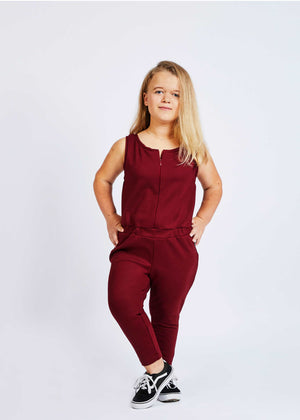 woman with dwarfism wearing wine red jumpsuit