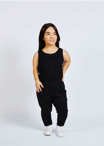 woman with dwarfism wearing black jumpsuit