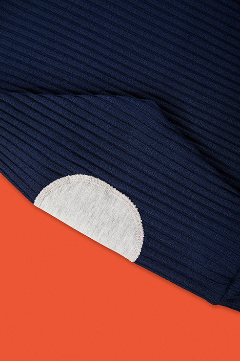 detailed view of grey application at elbow of blue pullover