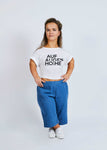 woman with dwarfism wearing blue jeans pants and white t-shirt