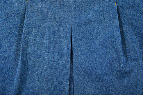 detailed view of folds of jeans skirt