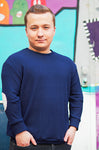 man with dwarfism wearing blue pullover 