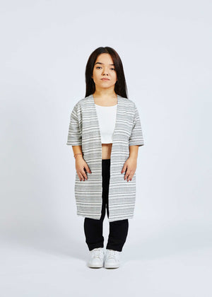 woman with dwarfism wearing striped kimono with black pants and white crop top