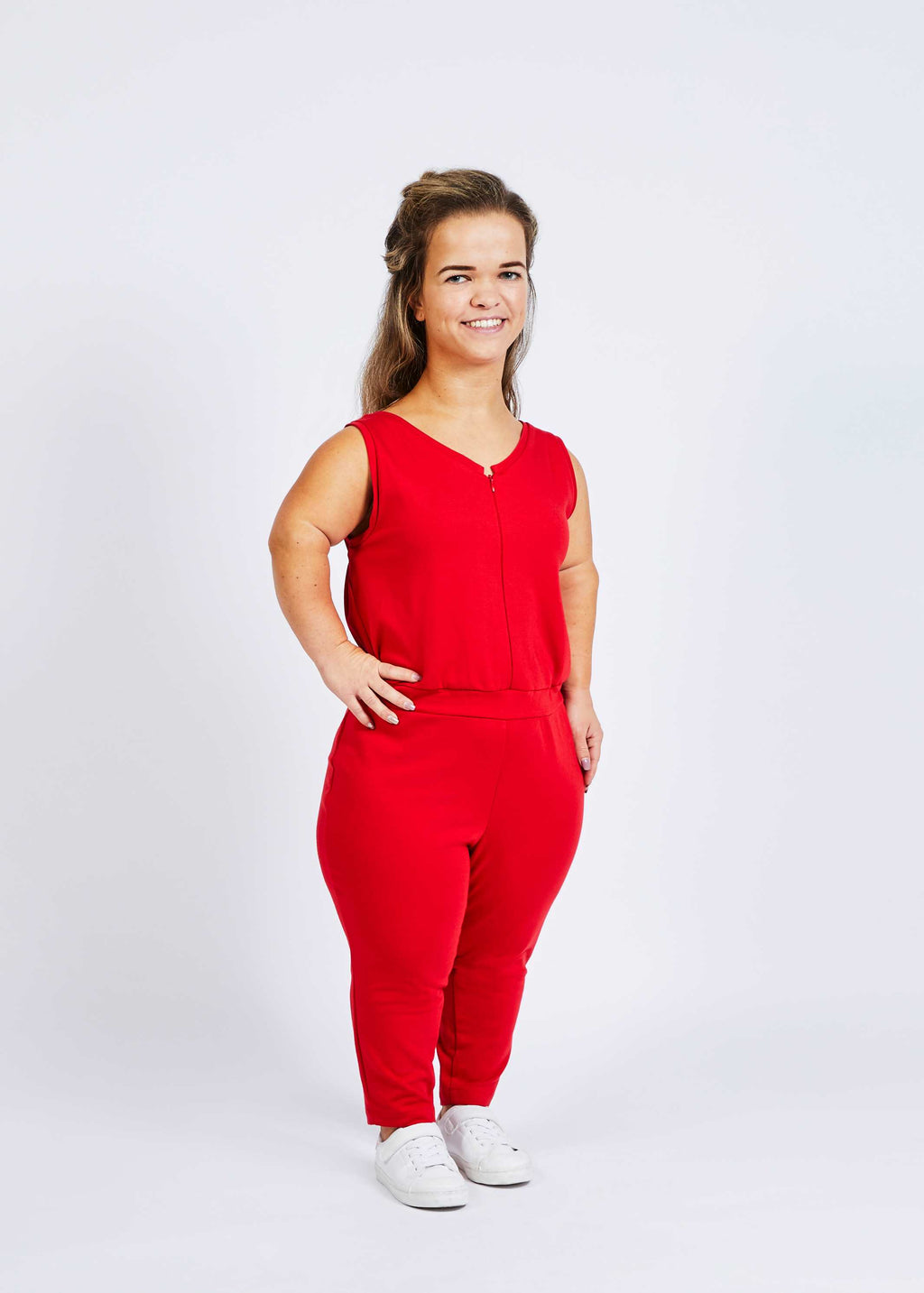woman with dwarfism wearing bright red jumpsuit