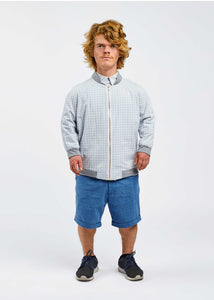 man with dwarfism wearing blue pants and light blue grid texture jacket