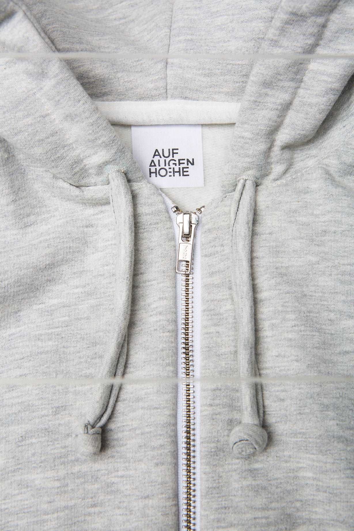 detailed view of grey hoodie zipper