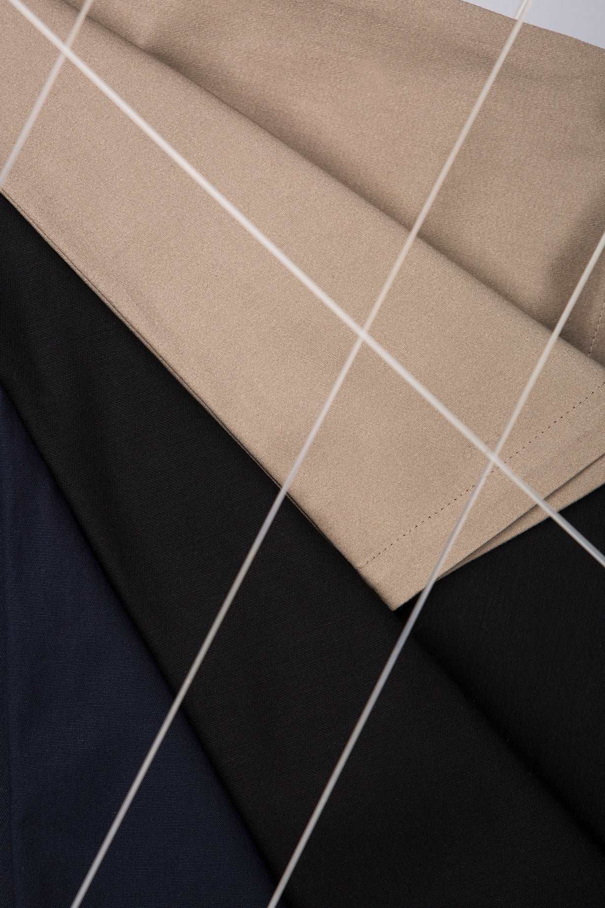 detailed view of sand, black and dark blue pants textures