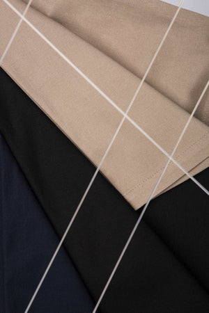 detailed view of sand, black and dark blue pants textures