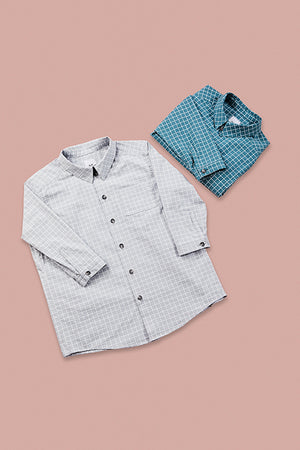grid patterned grey shirt and folded up grid pattern blue shirt on rose background